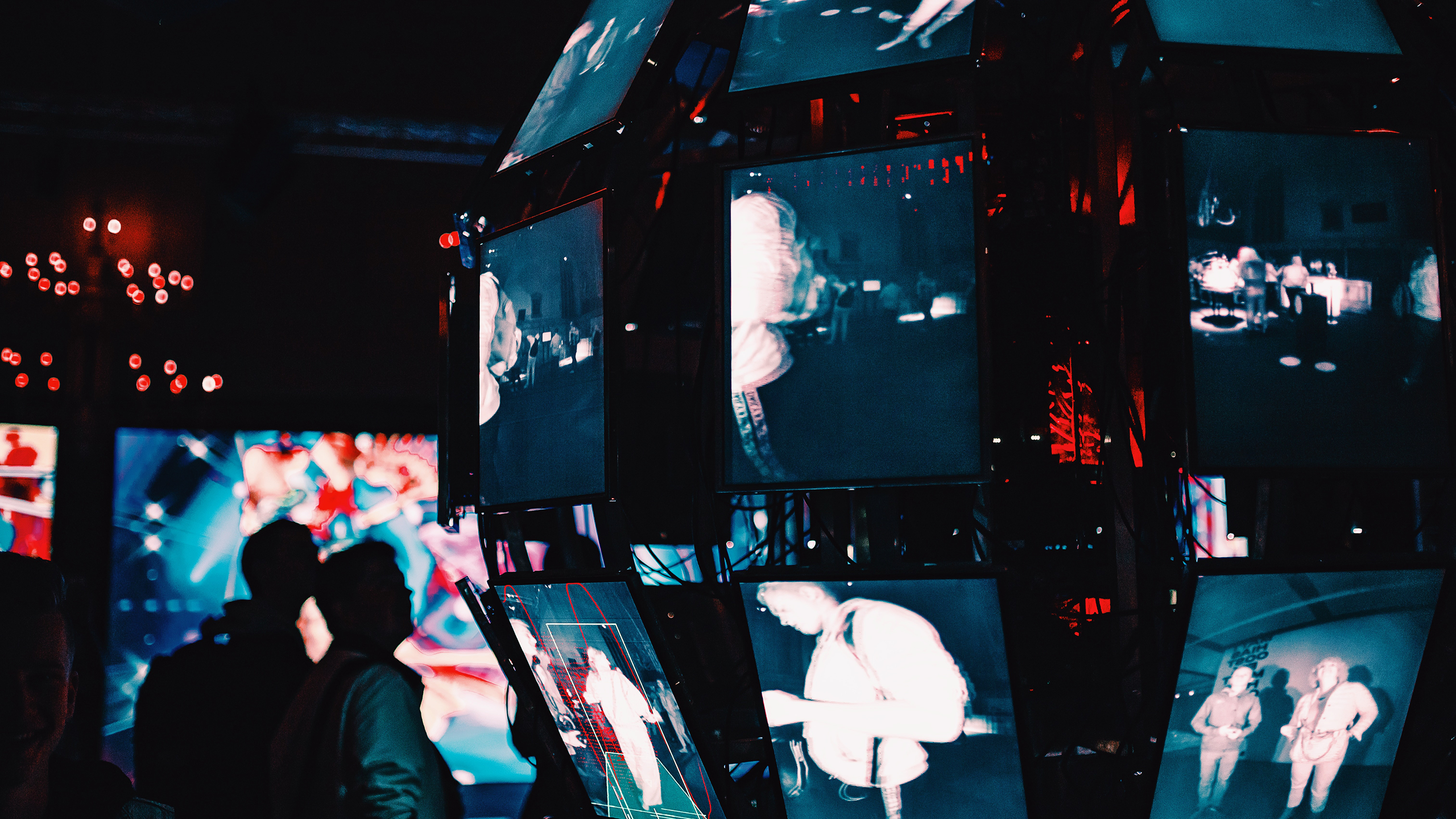 Photo of people standing around digital screens