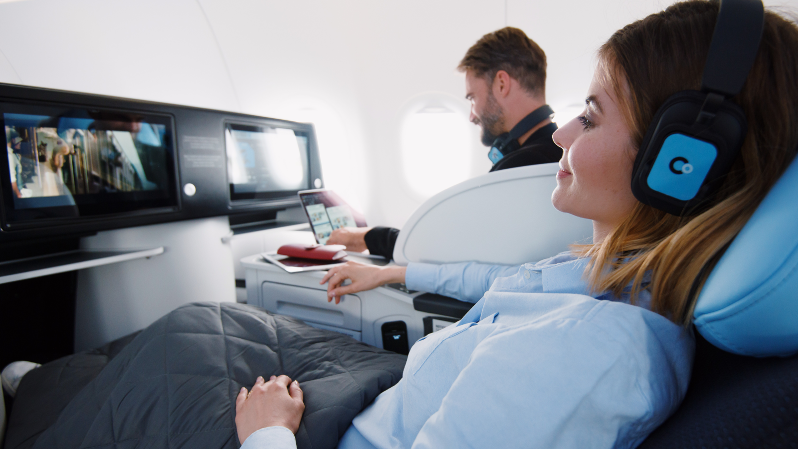 Photo of person laying down in a luxury airplane seat