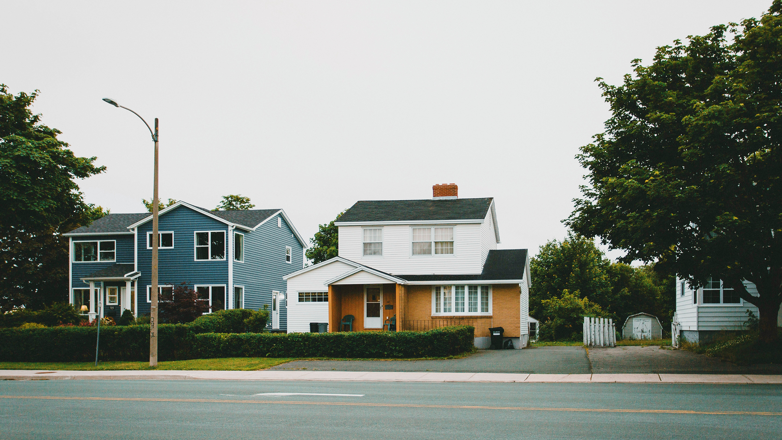 Photo of the exterior of a white and brown house