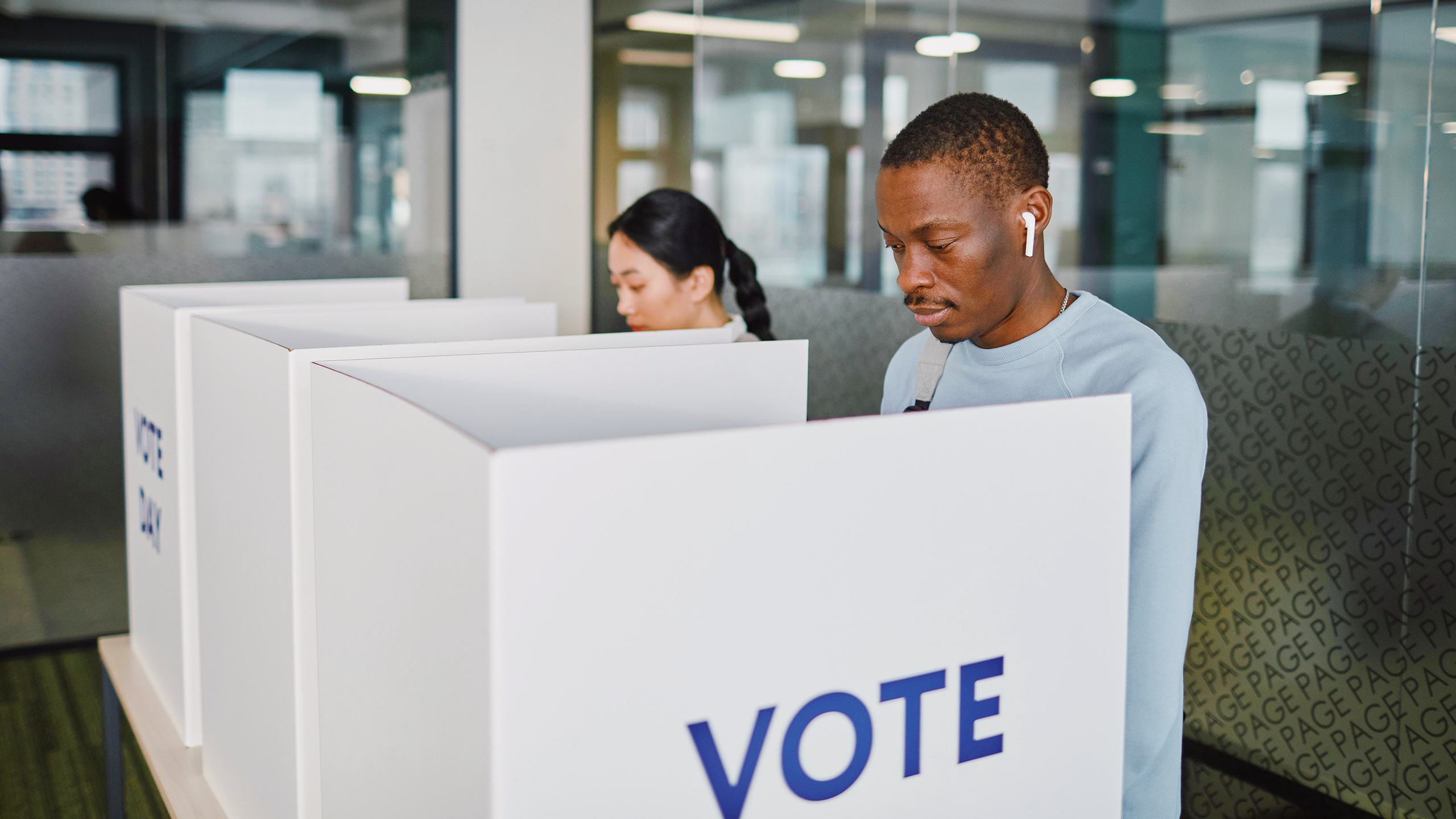 Photo of people casting ballots in voting booths