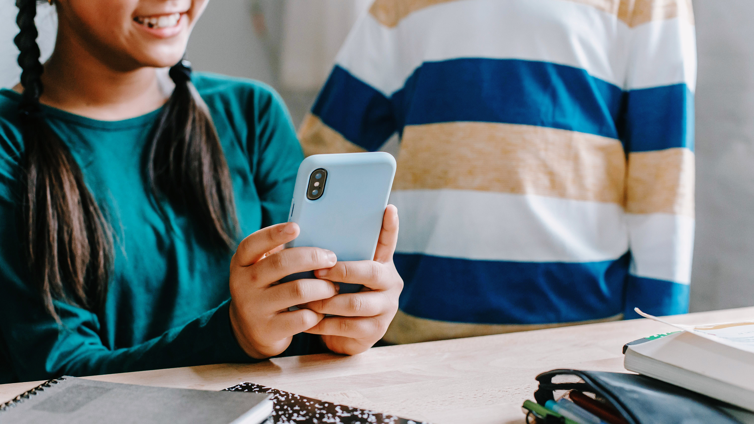 Photo of children scrolling on a phone