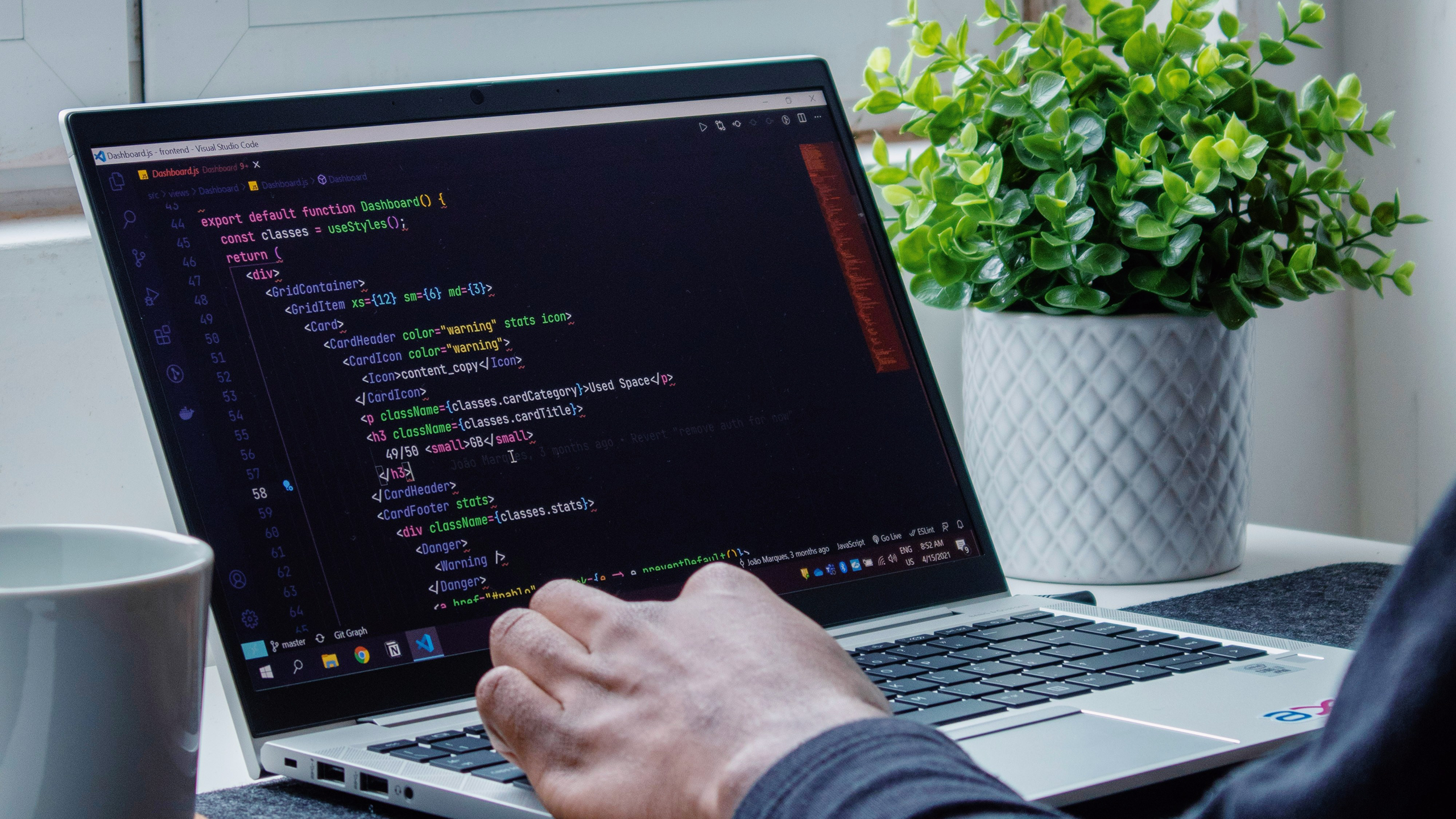 Photo of a person coding on a laptop