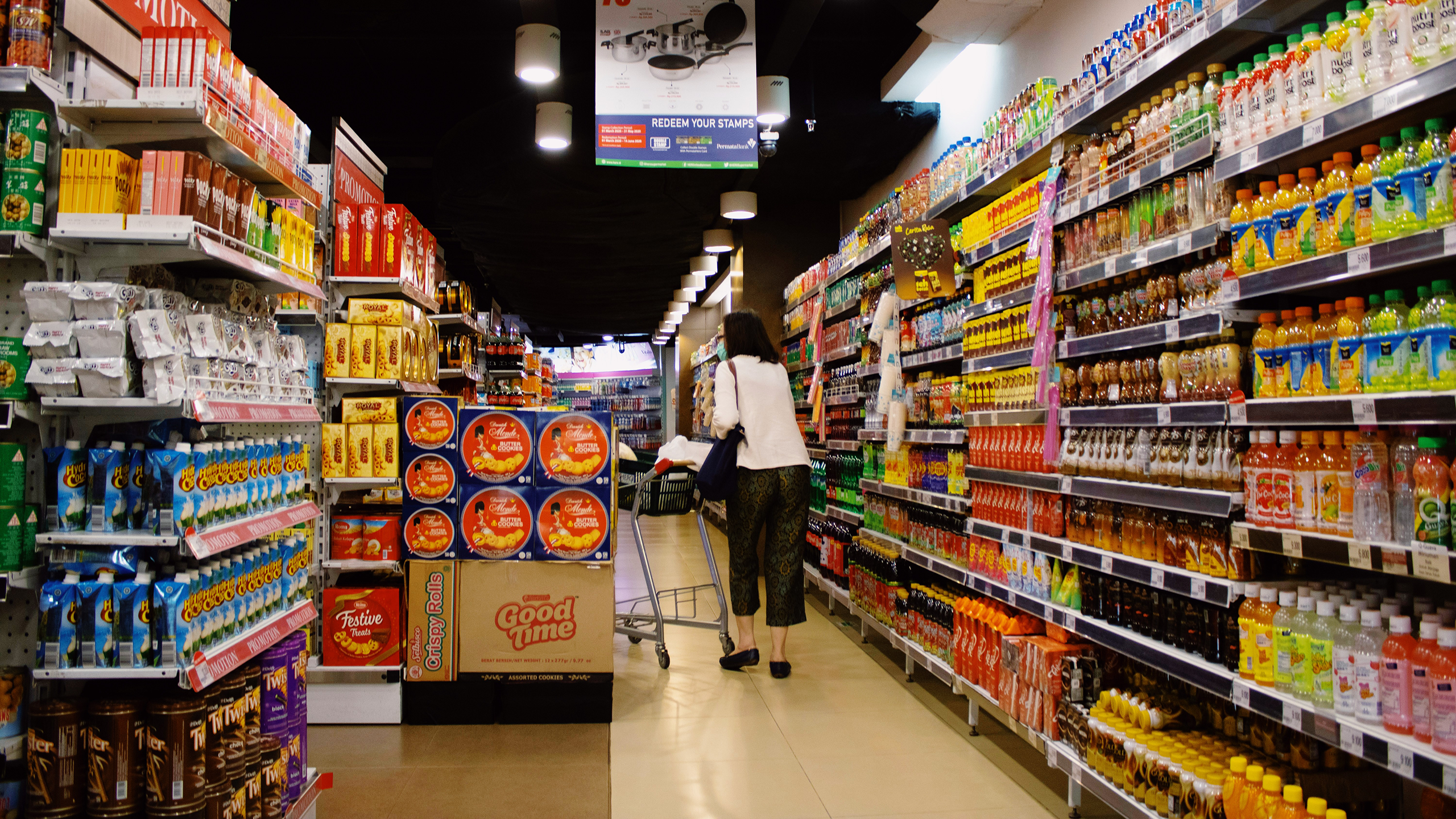 Photo of a person shopping in a grocery store aisle