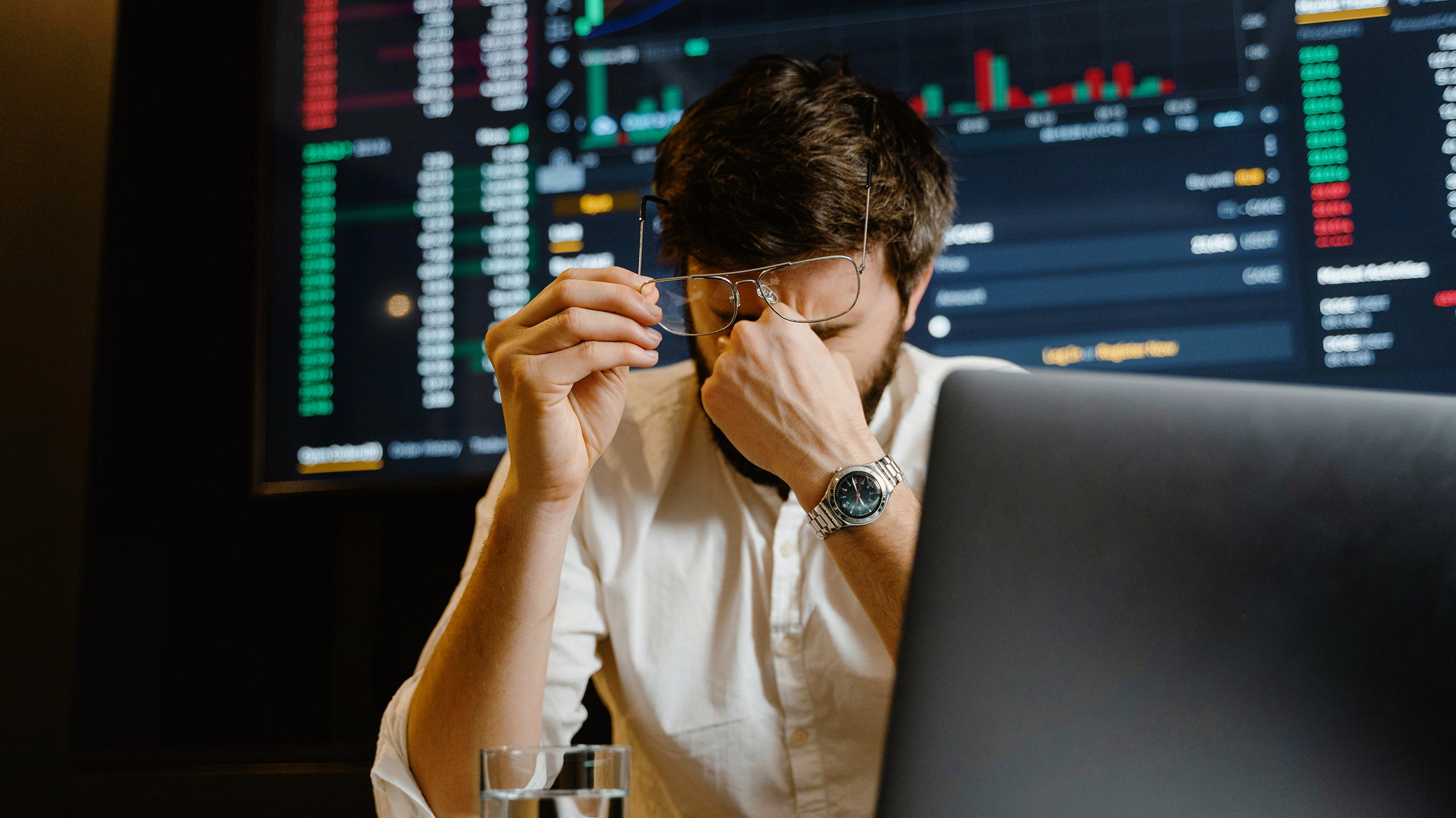 Photo of a man working and frustrated at his desk
