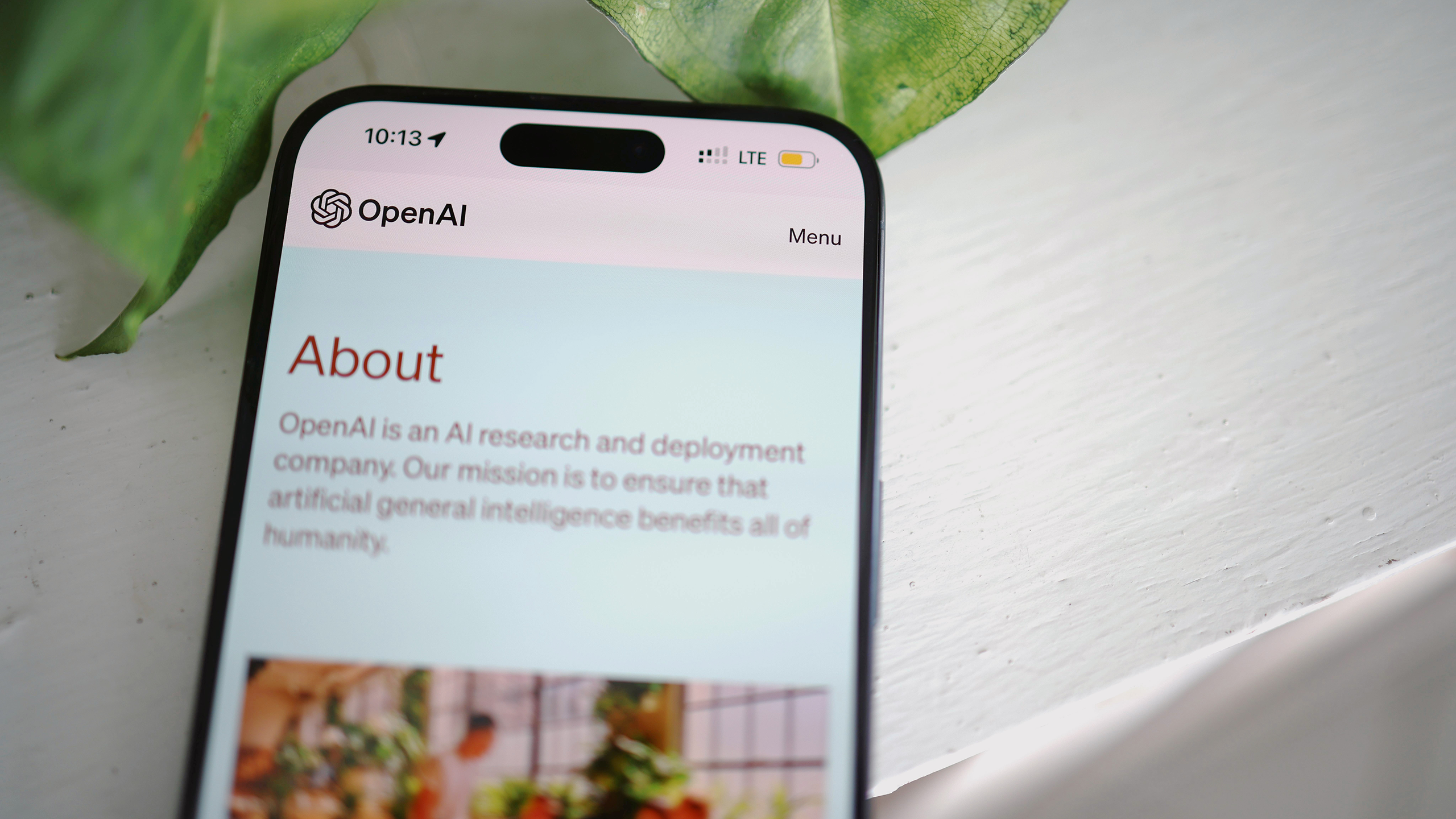 Photo of a phone open to OpenAI's website