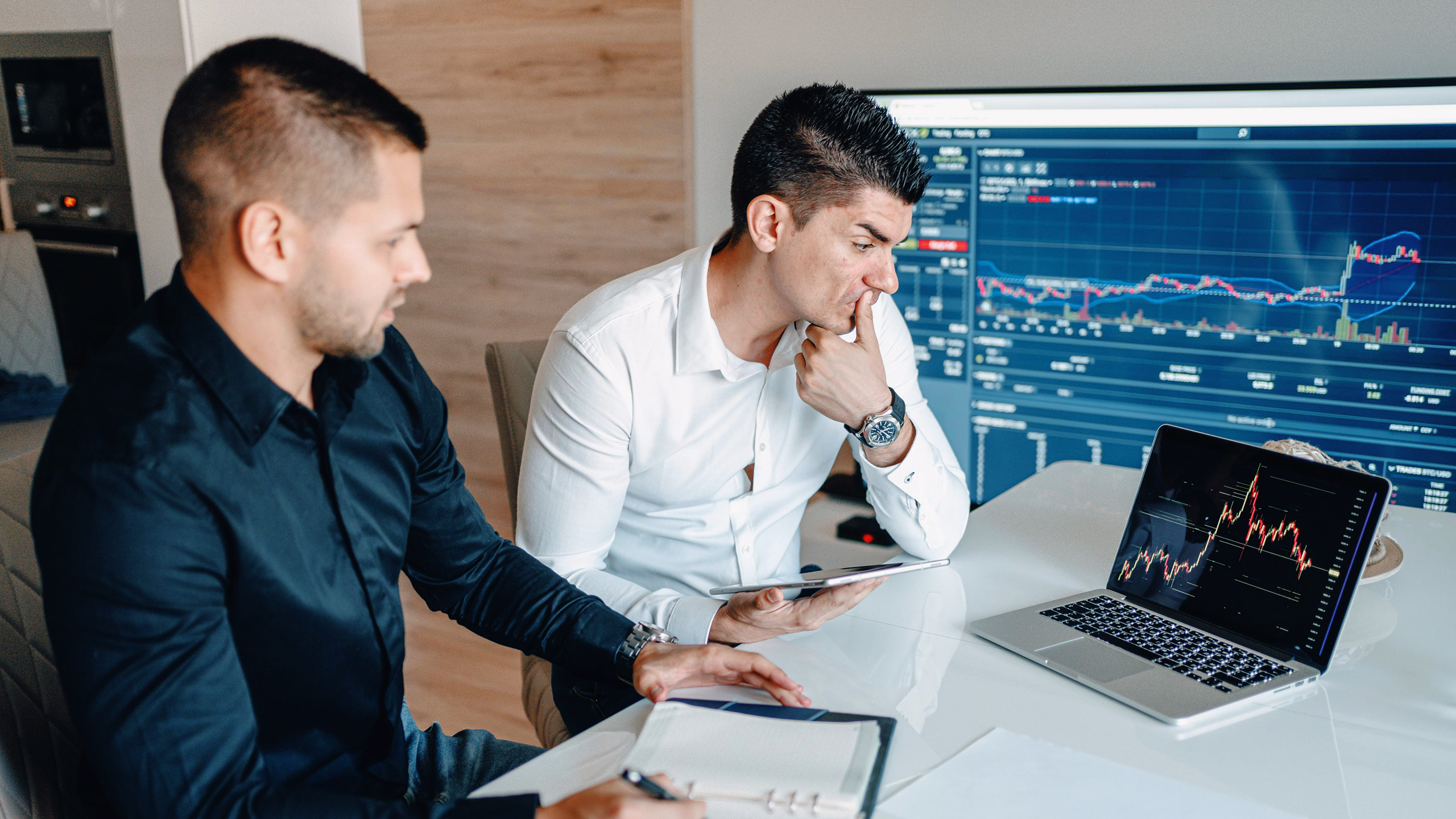 Photo of people looking at finance charts