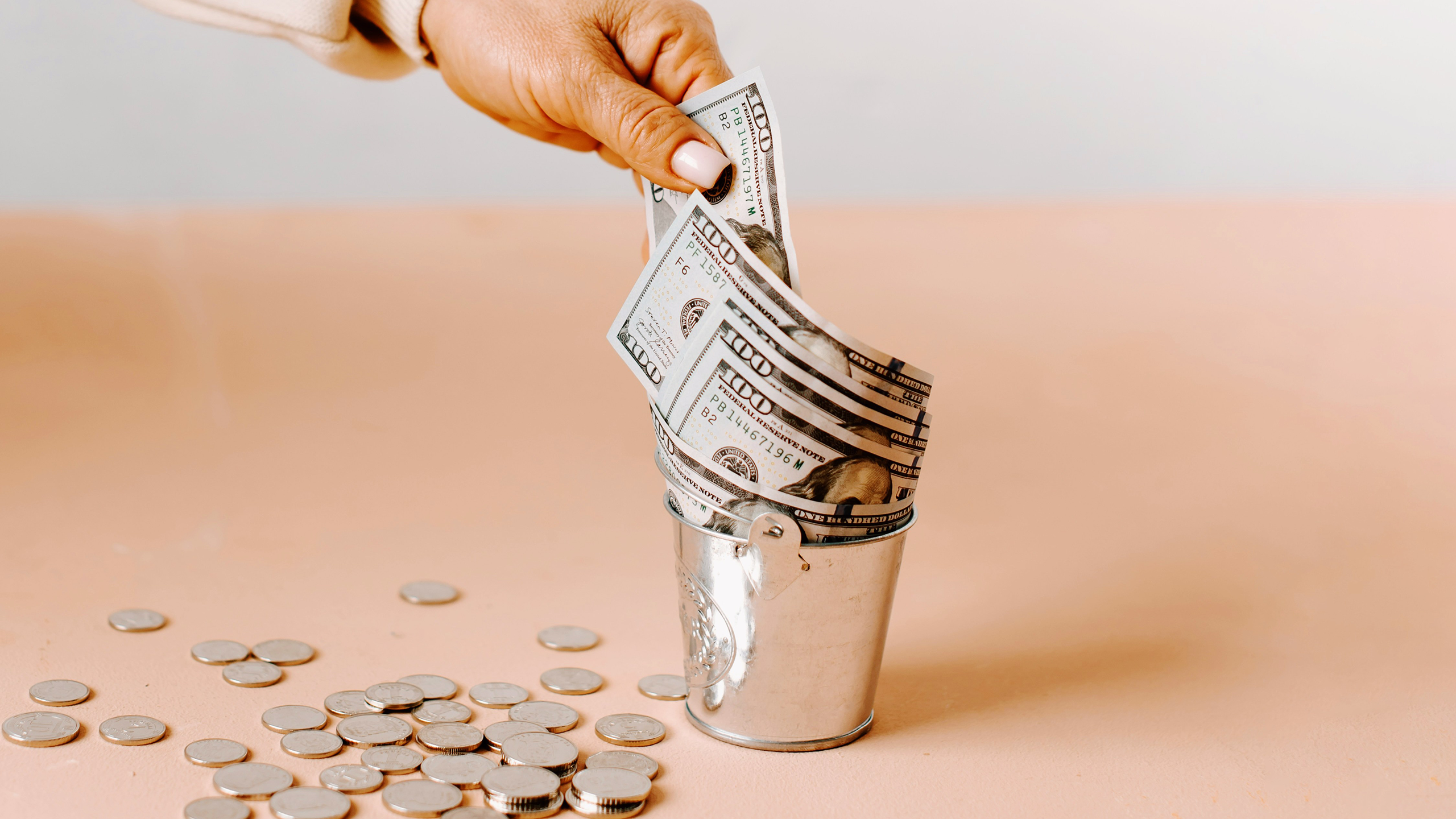 Photo of a person pulling money out of a container