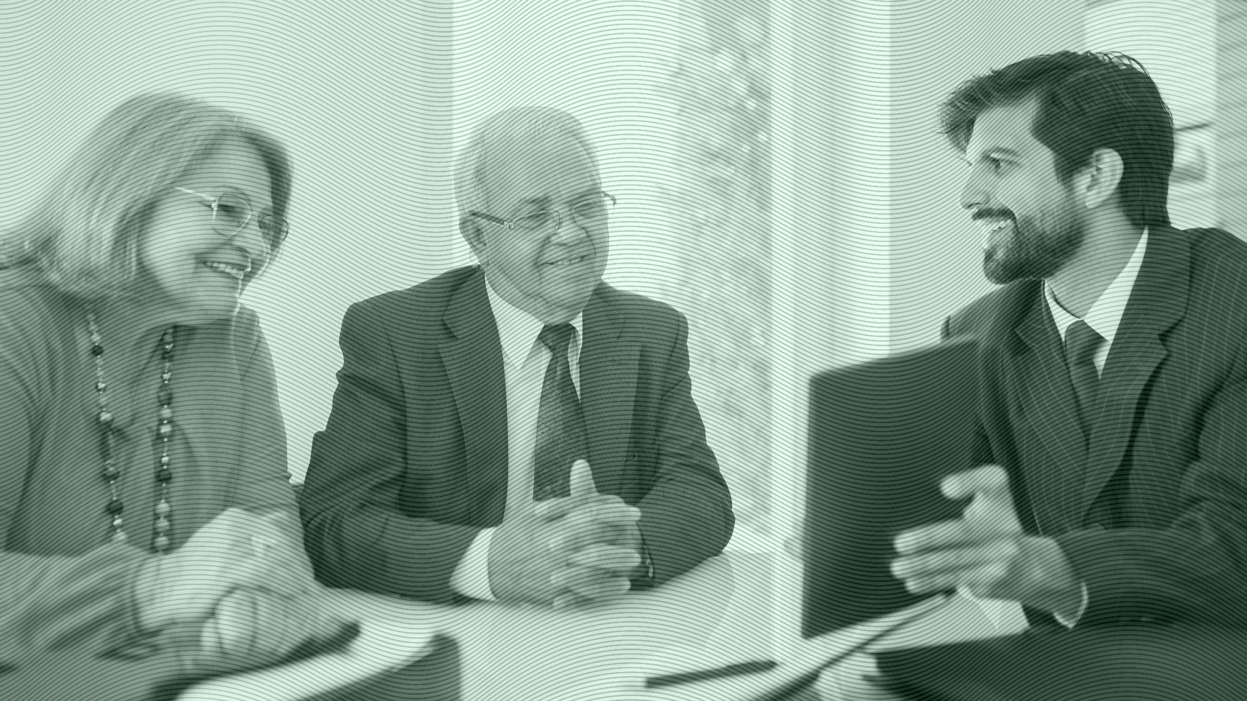 Photo of an advisor meeting with older clients