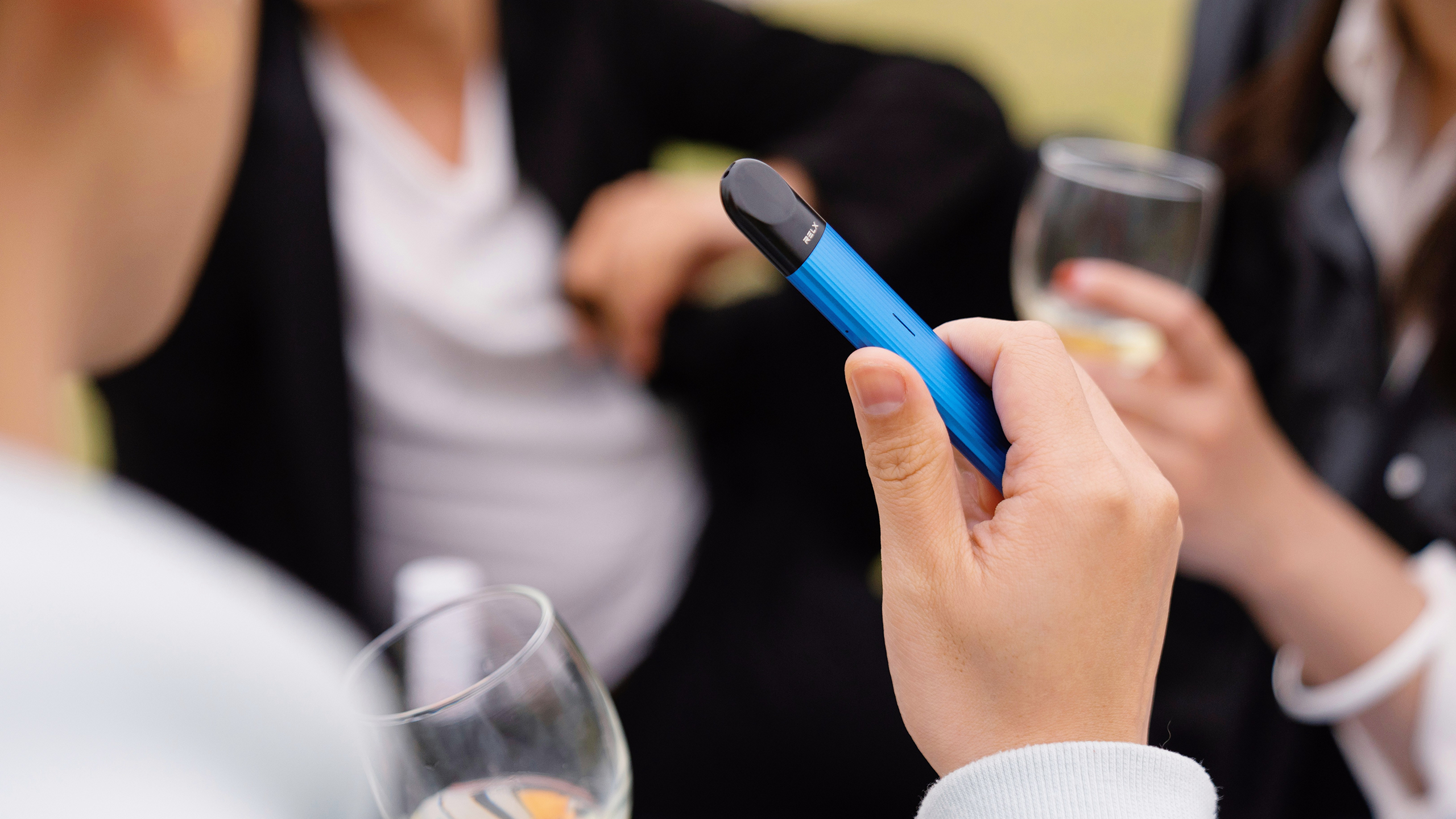 Photo of a person holding a vape