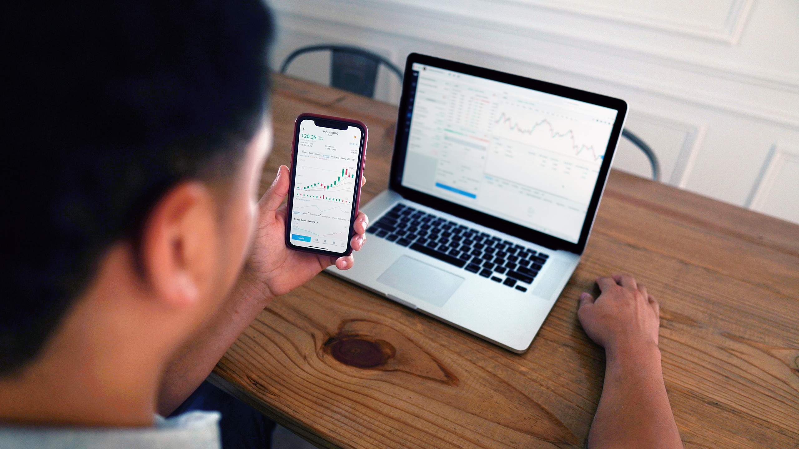 Photo of an individual investor looking at stock charts