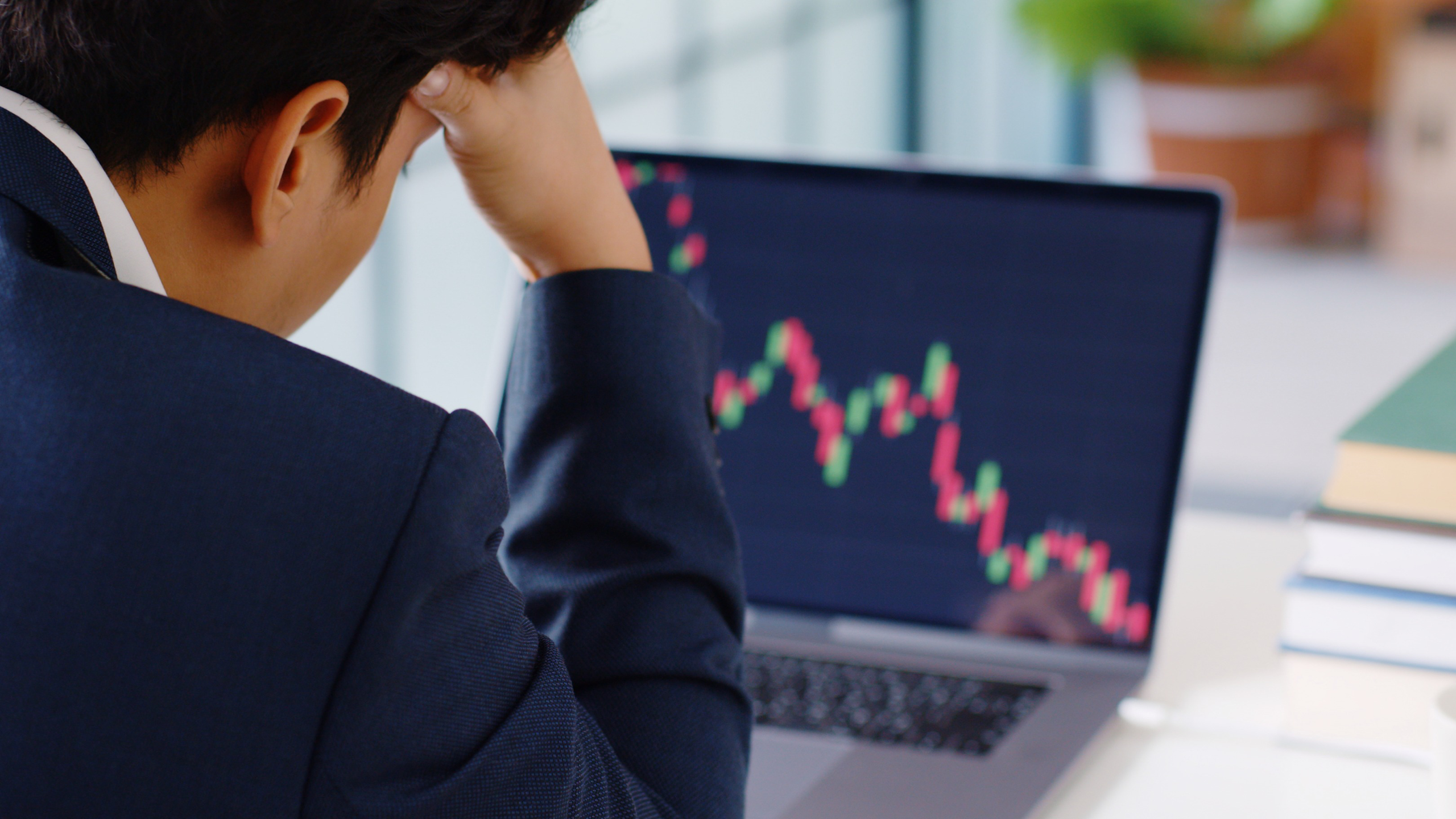 Photo of an investor looking at a stock chart