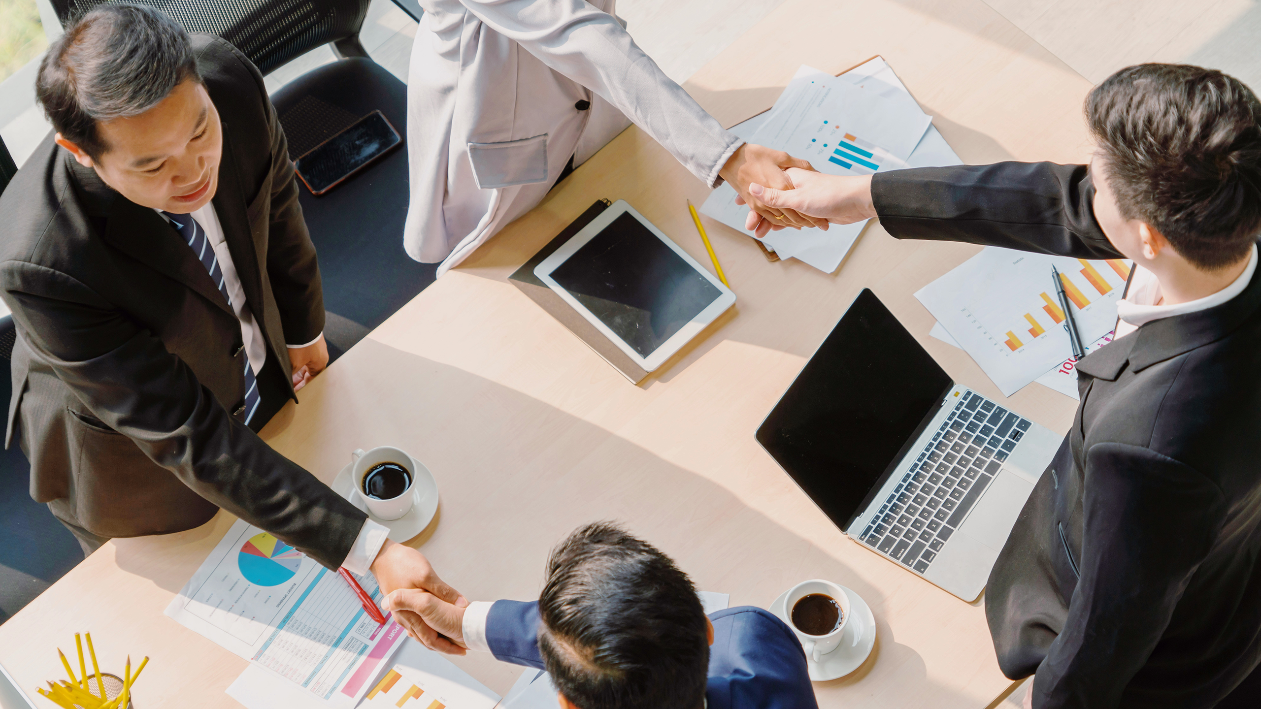 Photo of people shaking hands in a business meeting