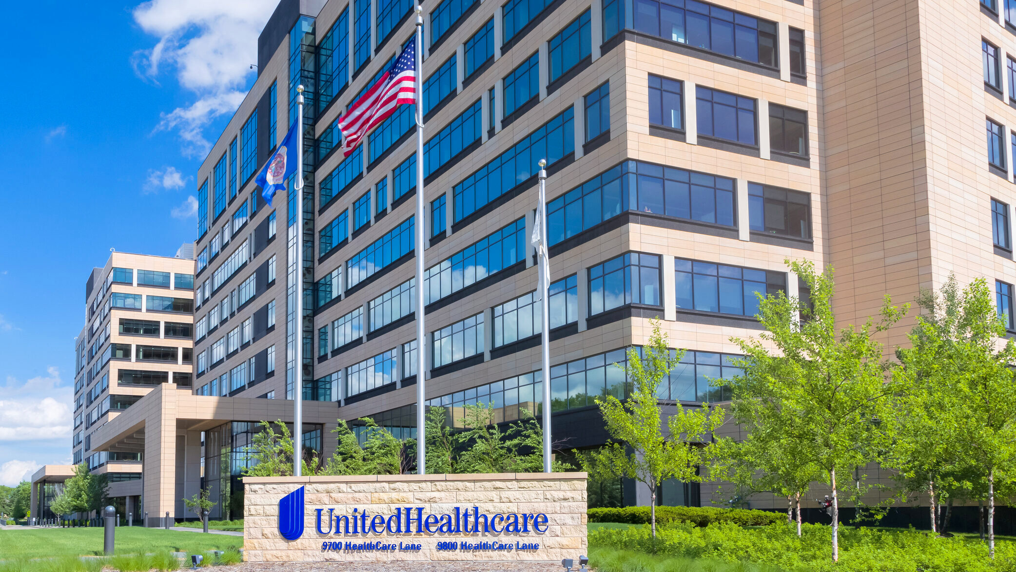 UnitedHealthcare's headquarters in Minneapolis, Minnesota are shown with a US and Minnesota state flag flying out in front.