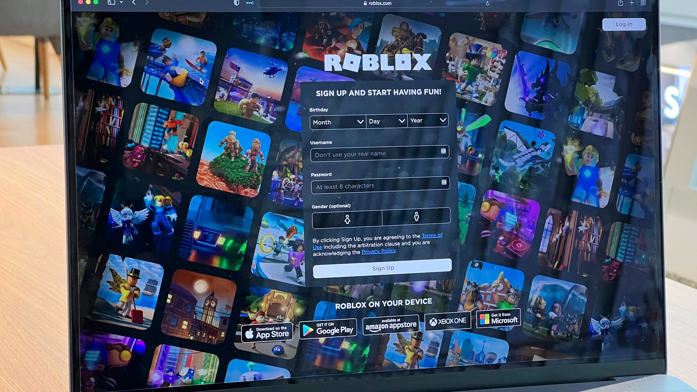 A laptop screen shows a sign-up page on the Roblox website where user's are asked to provide information about themselves.