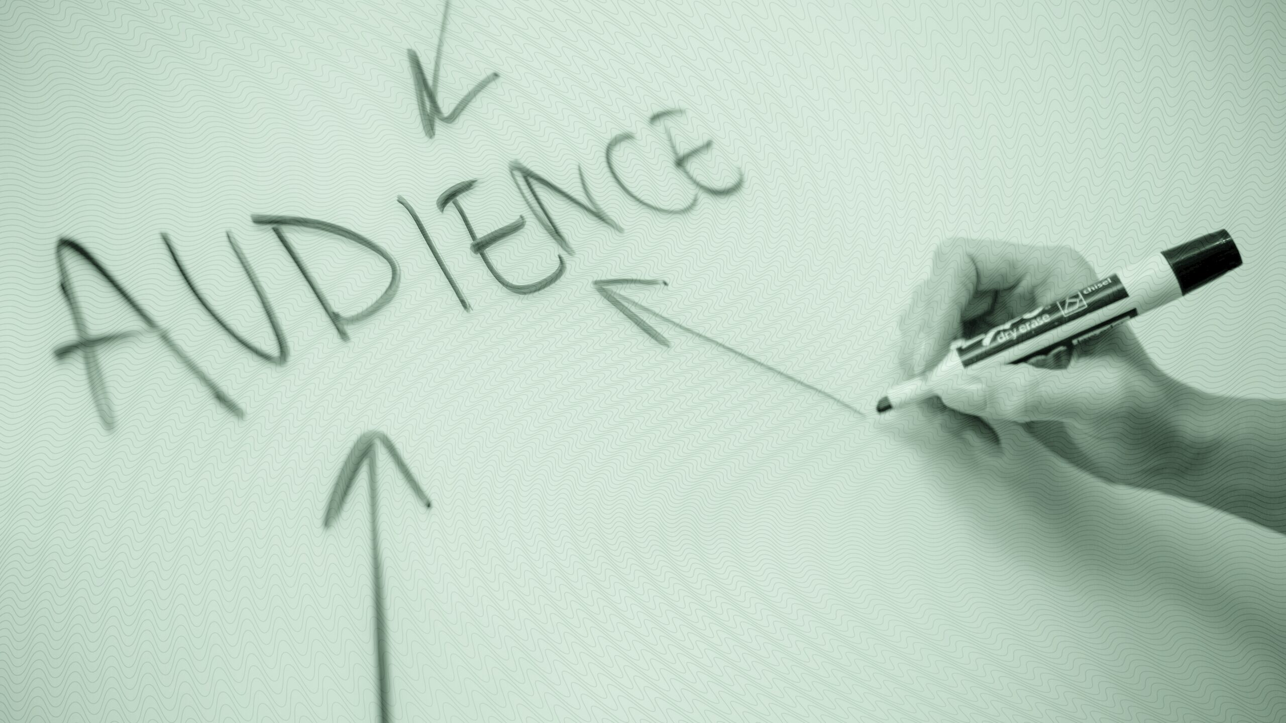 A person writing on a white board.