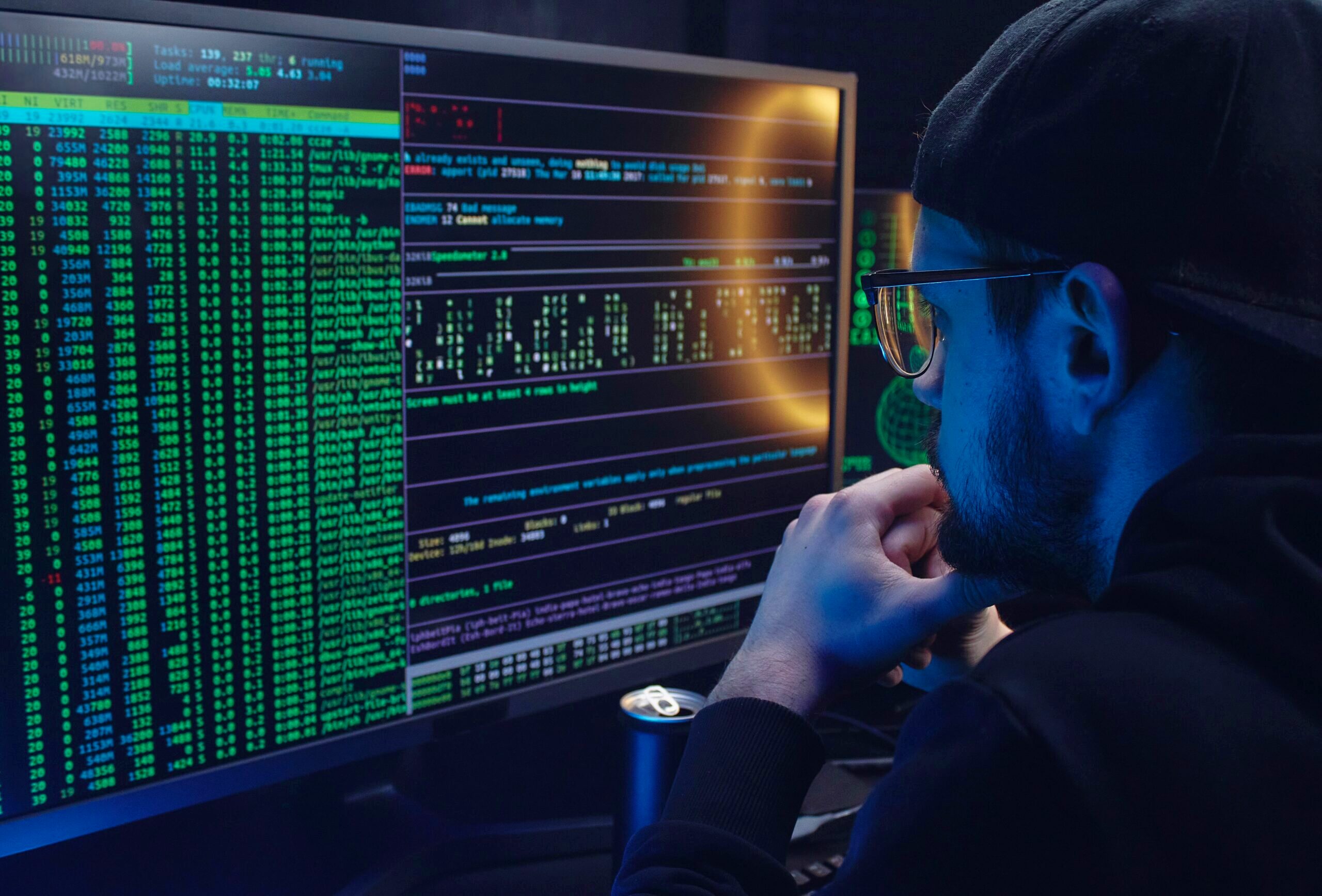 Photo of a man looking at lines of code.