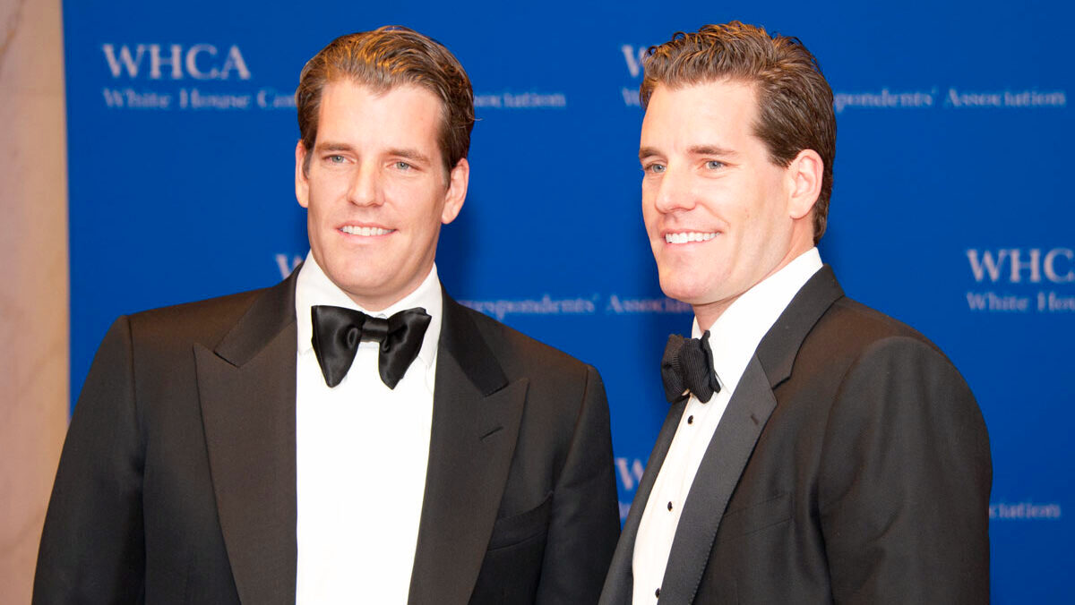 Brothers and identical twins Cameron and Tyler Winklevoss, cofounders of Gemini cryptocurrency exchange, stand next to each other in formal dress at a White House Correspondents' Association function.