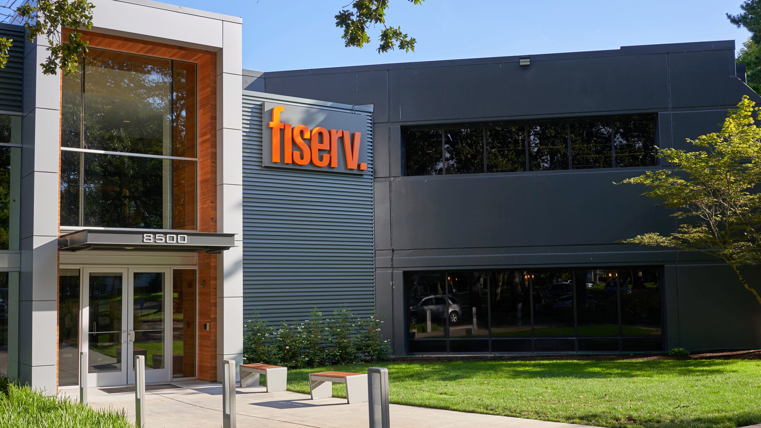 The exterior of a Fiserv office with the company's letter text logo is shown.