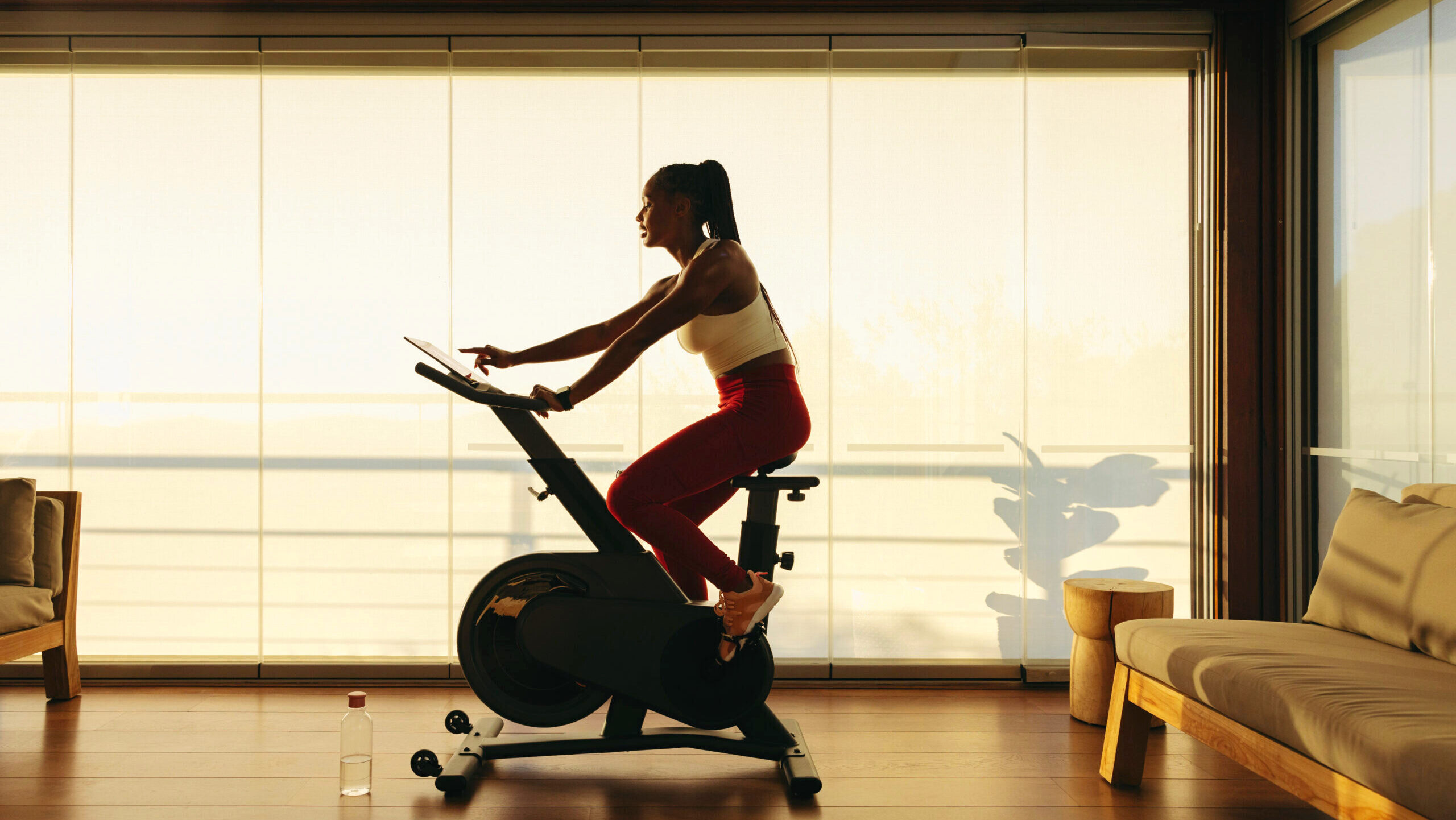 Photo of a woman riding an exercise bike.