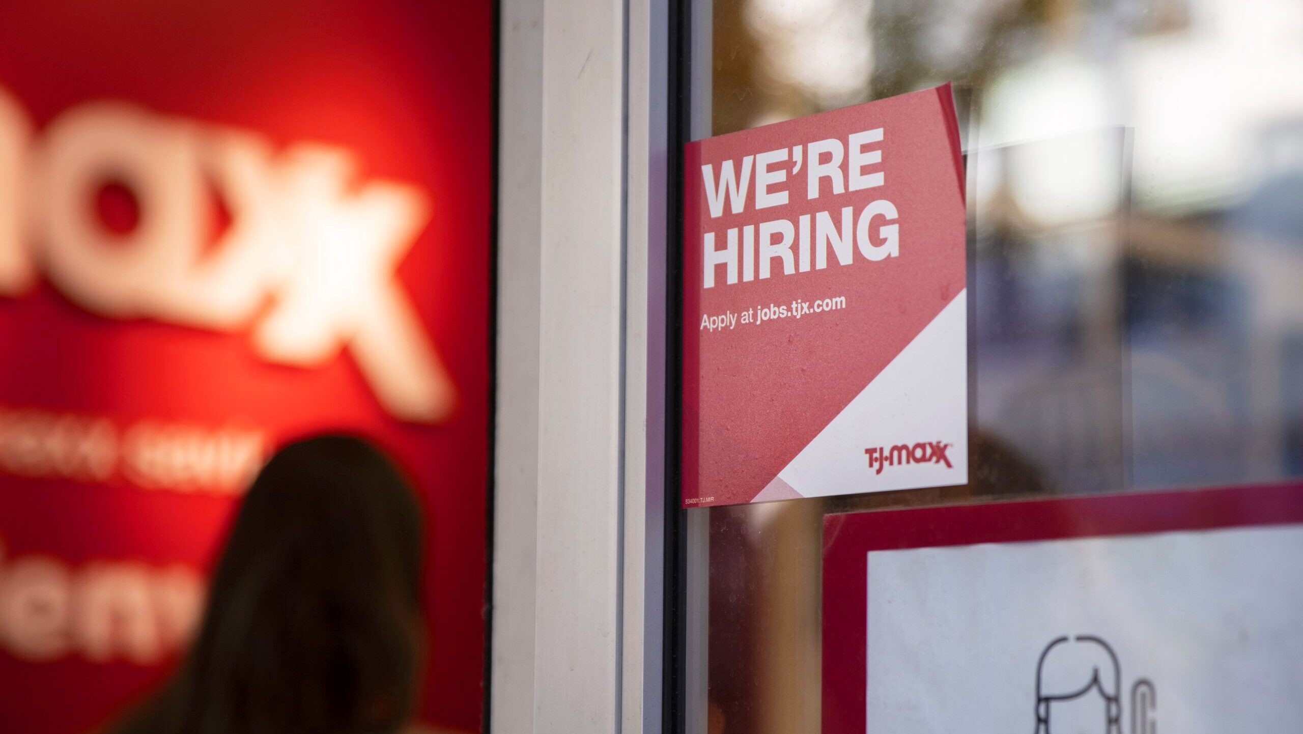 Photo of a hiring sign outside a business.