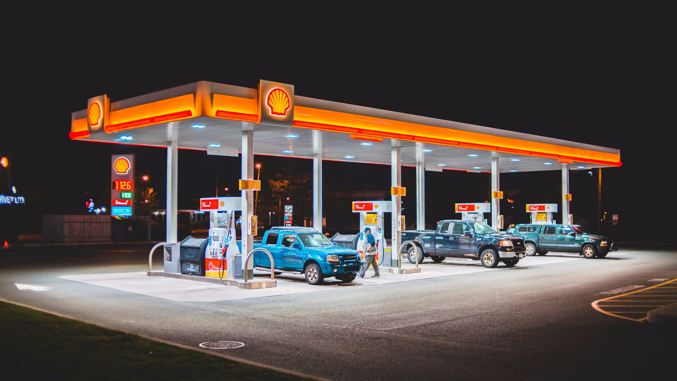 Cars are shown parked at a Shell gas station.