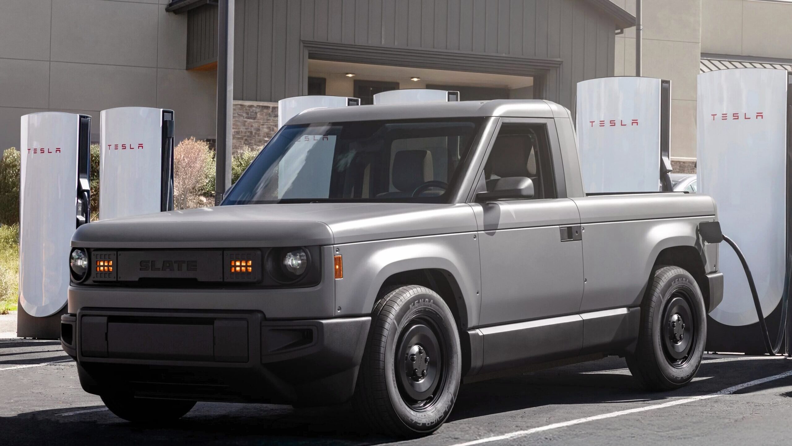 Photo of a Slate Auto truck at a charging station.